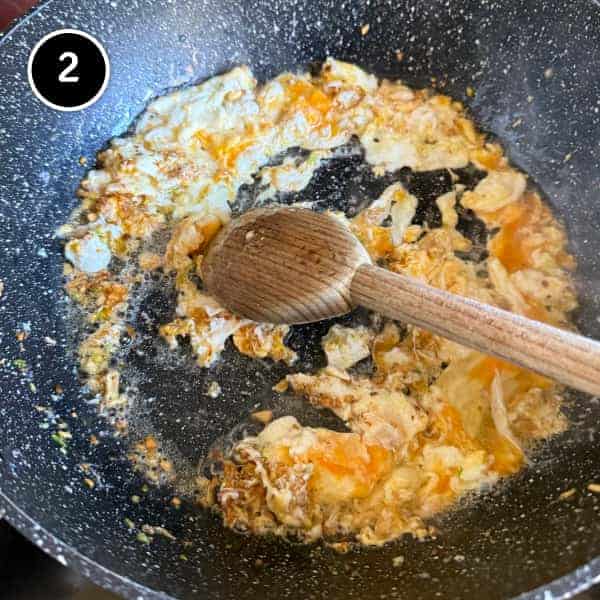 Vietnamese Crab Fried Rice | cookeatworld.com Scrambled eggs and aromatics cooking together in a wok