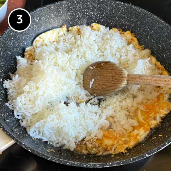 Vietnamese Crab Fried Rice | cookeatworld.com Cold jasmine rice being tossed with egg and aromatics in a wok