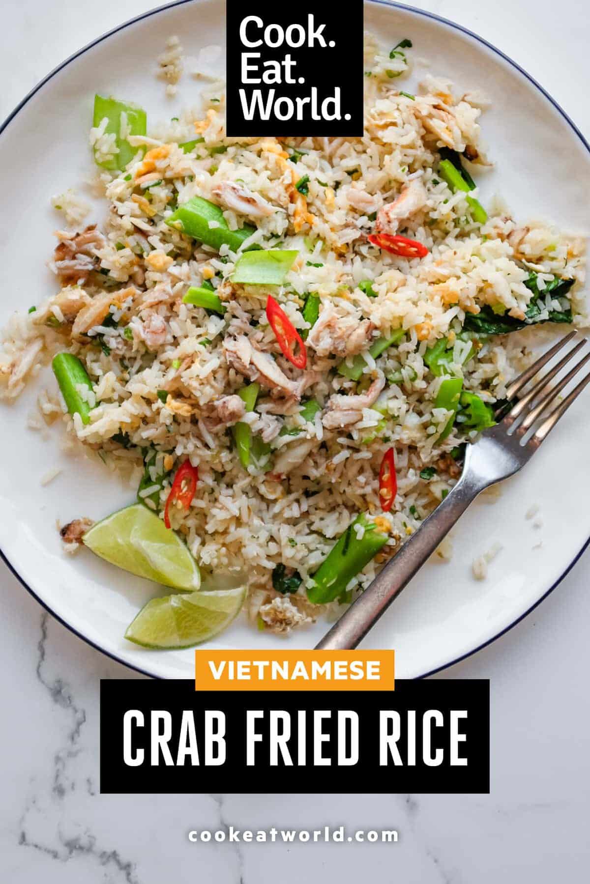 Overhead view of Vietnamese crab fried rice served with fresh lime wedges