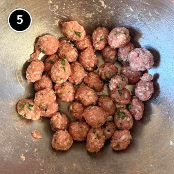 Small seasoned pork meatballs shaped and ready to cook in the Thai rice soup
