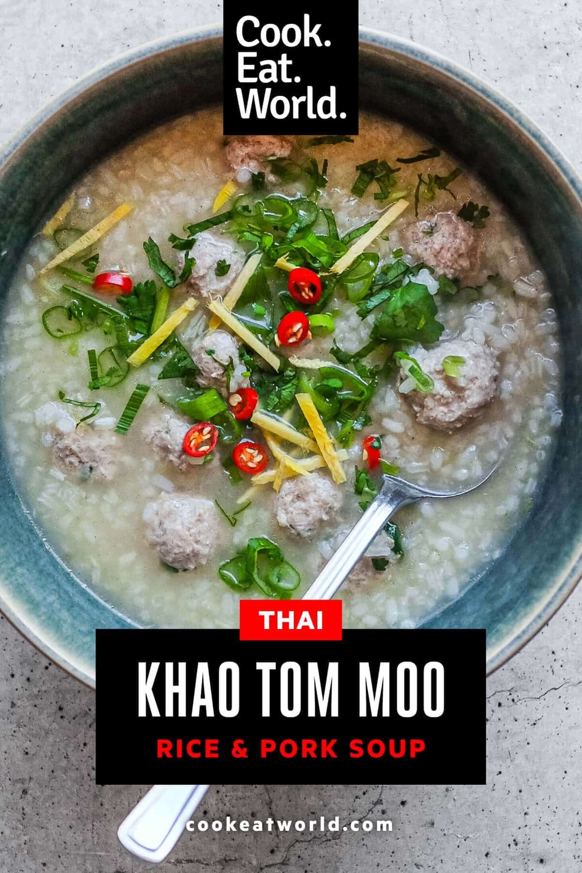 Spoonful of Thai rice soup showing tender pork meatballs and distinct grains of broken rice