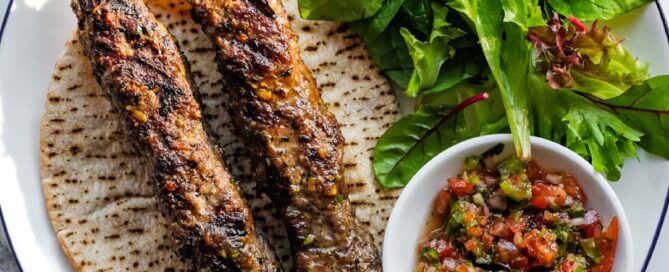 Traditional Turkish lamb kebabs inspired by Gaziantep with fresh salad accompaniments.