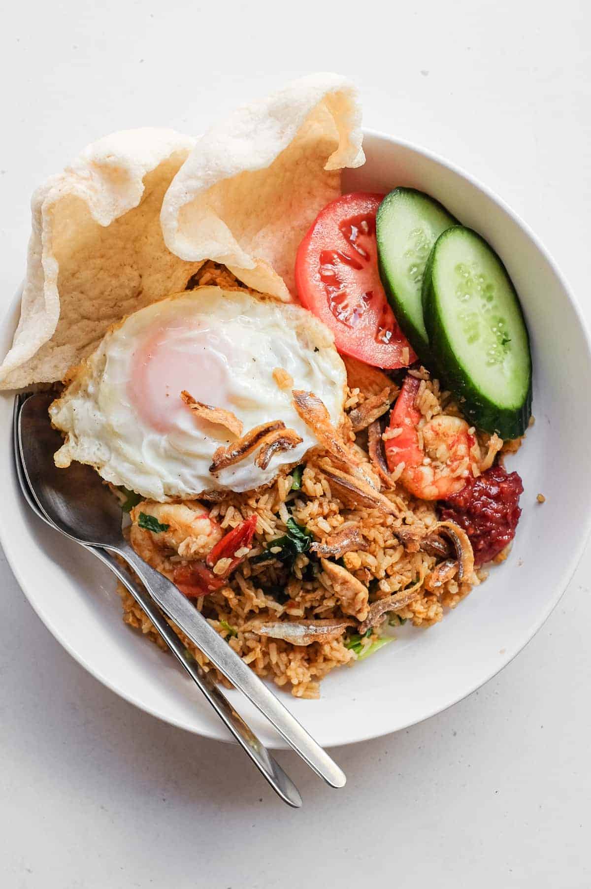 Malaysian nasi goreng kampung topped with a crispy fried egg and ikan bilis