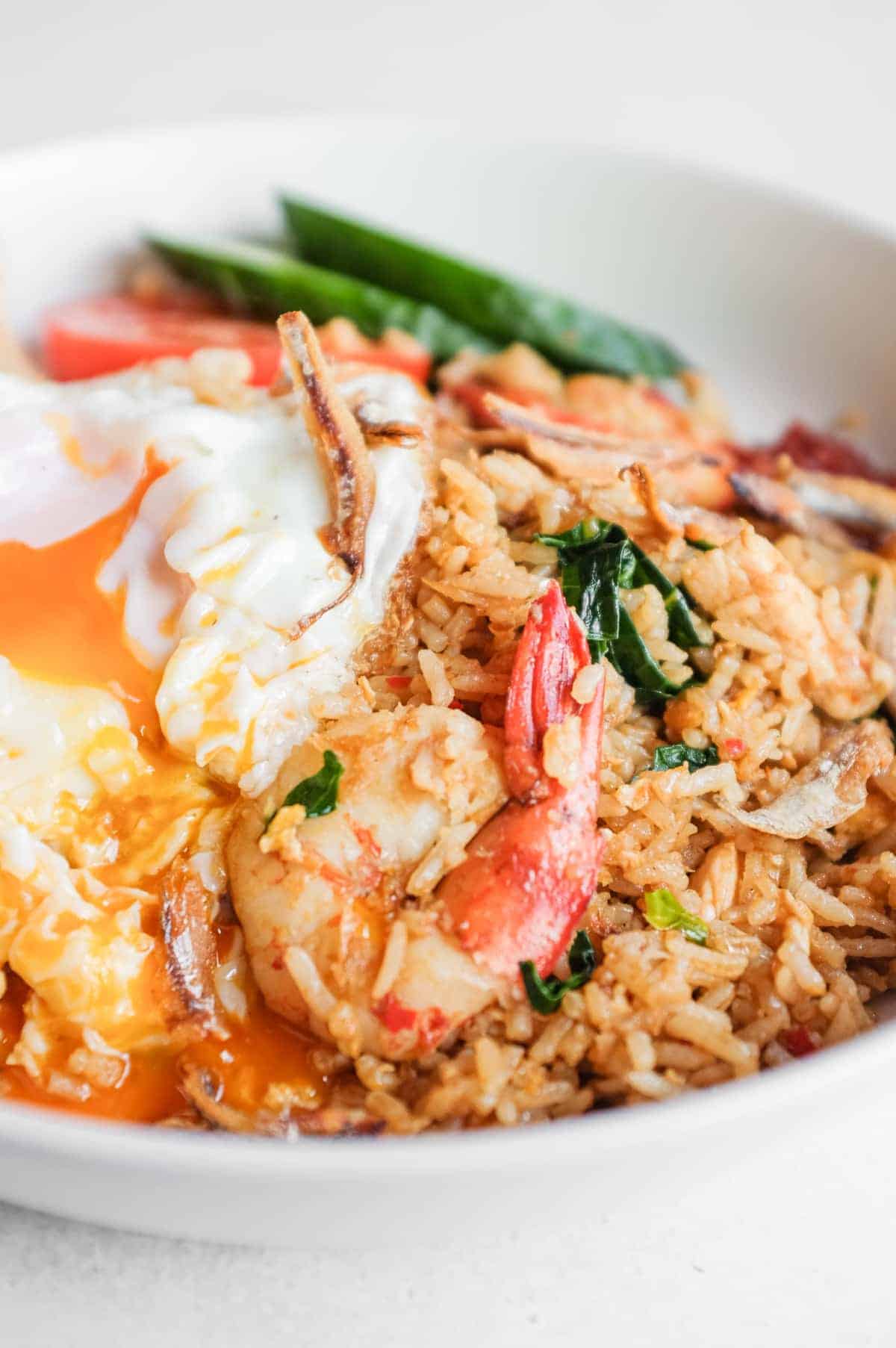 Nasi goreng kampung served with cucumber, tomato and prawn crackers