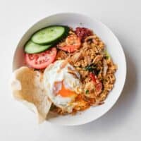 Crispy fried egg with a runny yolk served over Malaysian fried rice