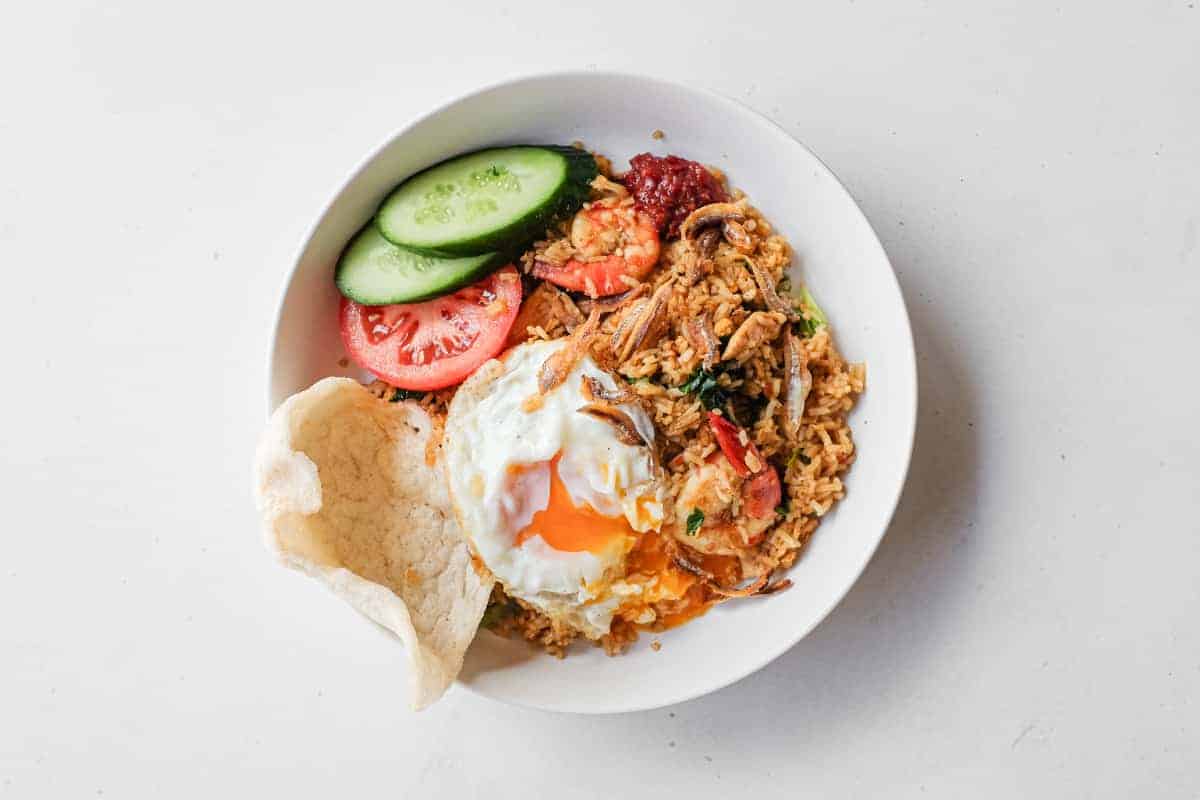Crispy fried egg with a runny yolk served over Malaysian fried rice