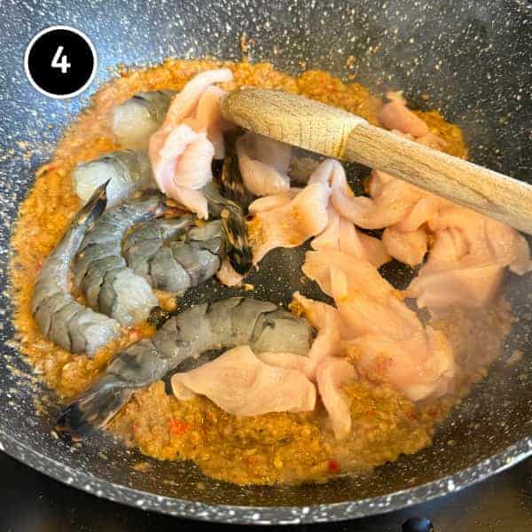 Nasi Goreng Kampung (Malaysian Fried Rice) | cookeatworld.com Nasi goreng spice paste cooking with chicken and prawns in a wok