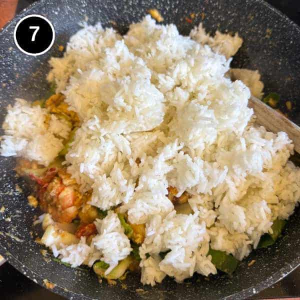 Nasi Goreng Kampung (Malaysian Fried Rice) | cookeatworld.com Cooked jasmine rice being tossed with nasi goreng ingredients