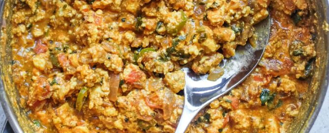 A pan of authentic Paneer Bhurji made with crumbled paneer, tomatoes and Indian spices.