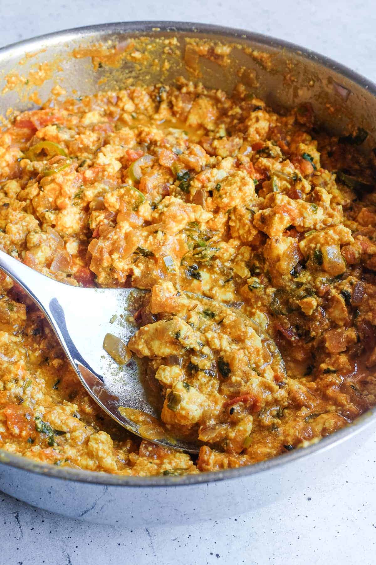Freshly cooked Paneer Bhurji in a saut&eacute; pan with cilantro and warming spices.