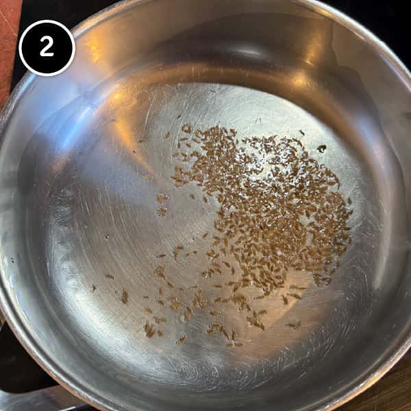 Paneer Bhurji (Indian Scrambled Paneer) | cookeatworld.com Cumin seeds blooming in oil for paneer bhurji