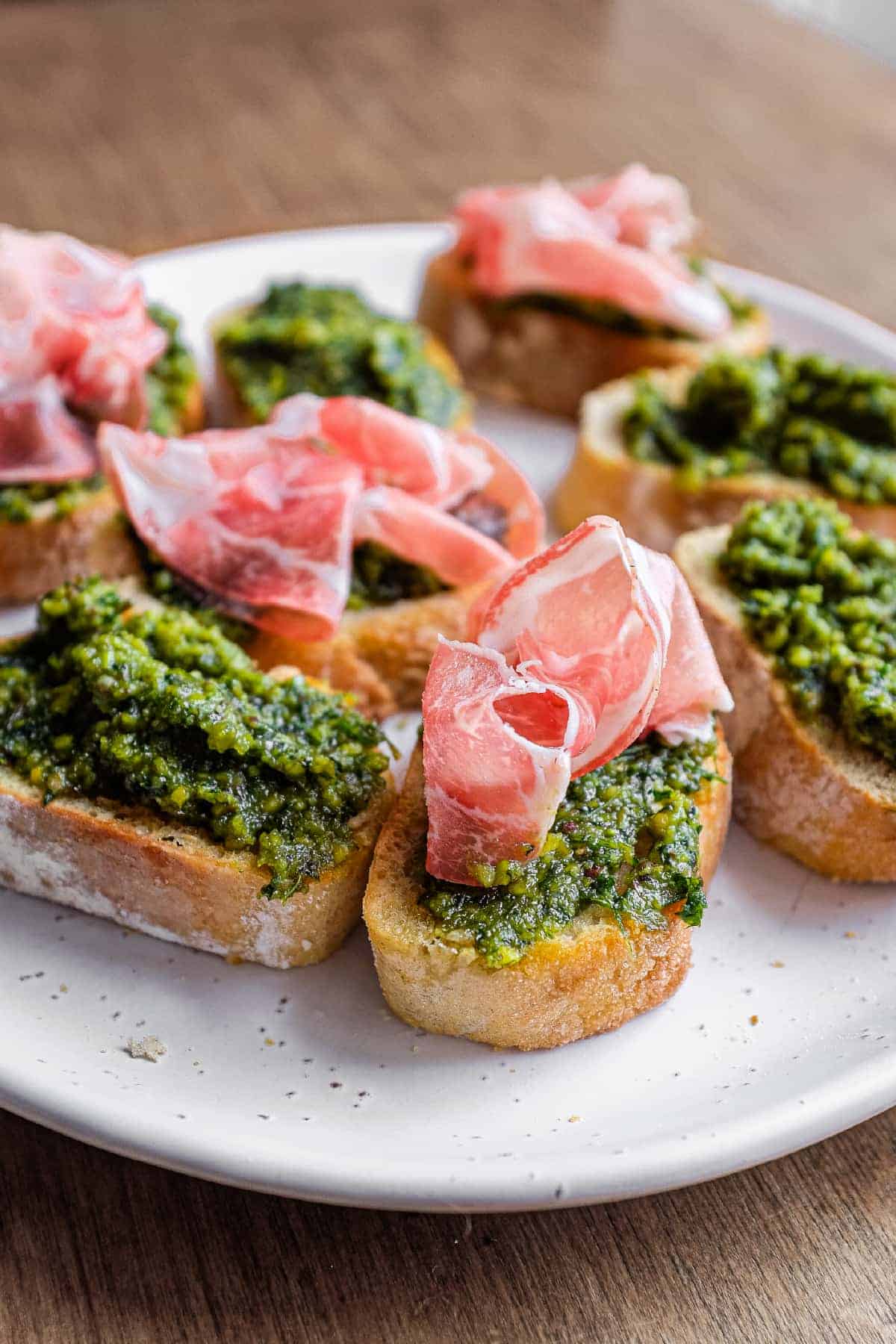Toasted crostini spread with Sicilian pistachio pesto and finished with slices of prosciutto.