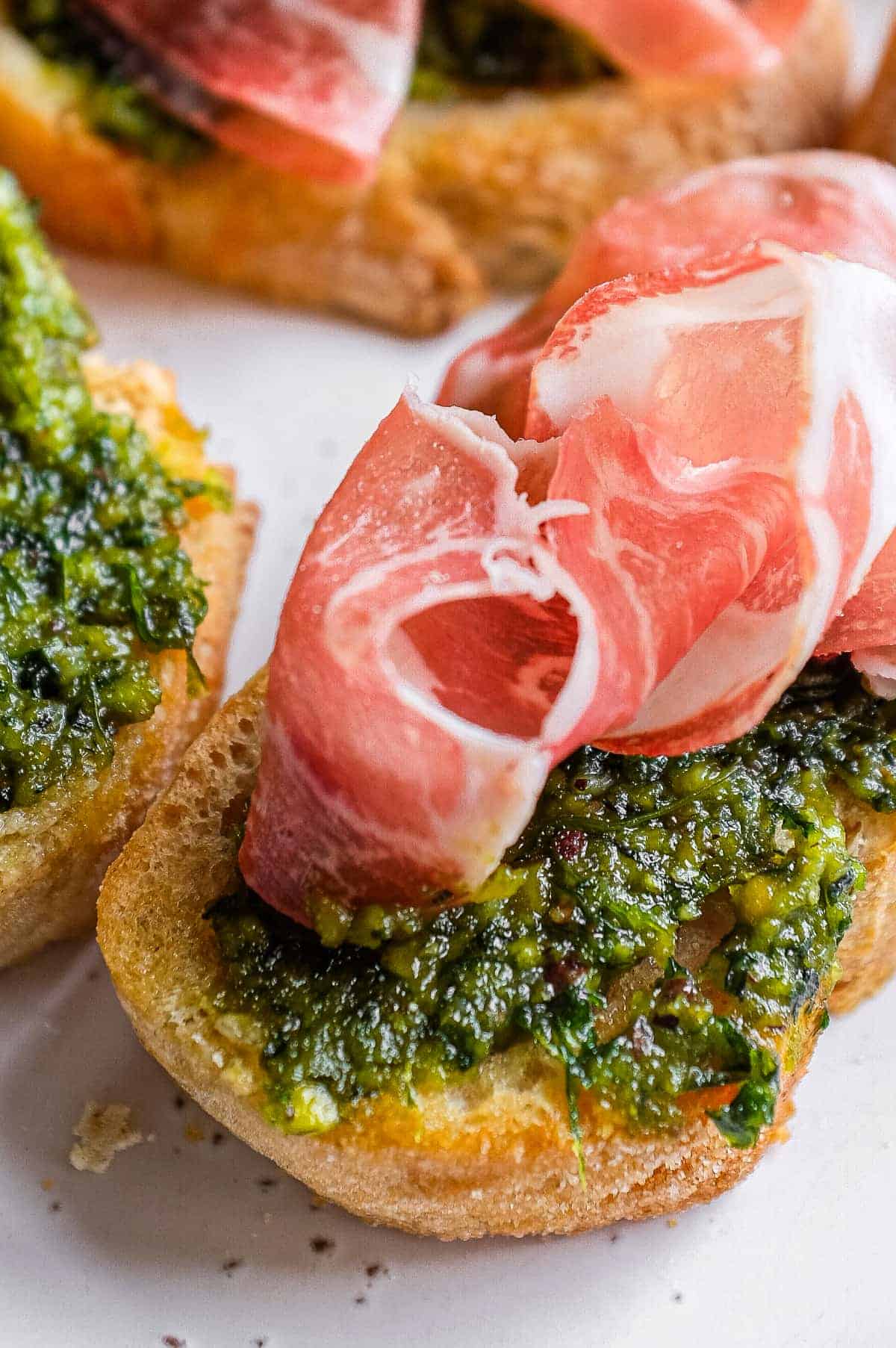 Crunchy crostini topped with fresh Sicilian pistachio pesto and thin slices of prosciutto.