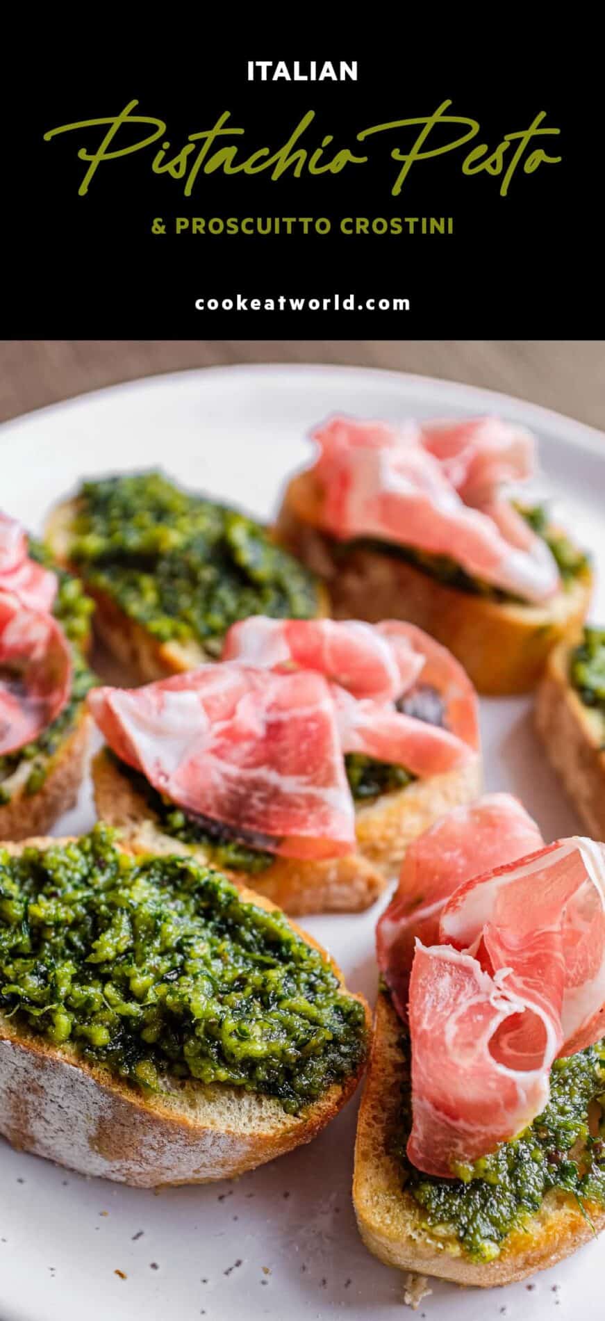 A rustic platter of Italian crostini with vibrant pistachio pesto and delicate slices of prosciutto.