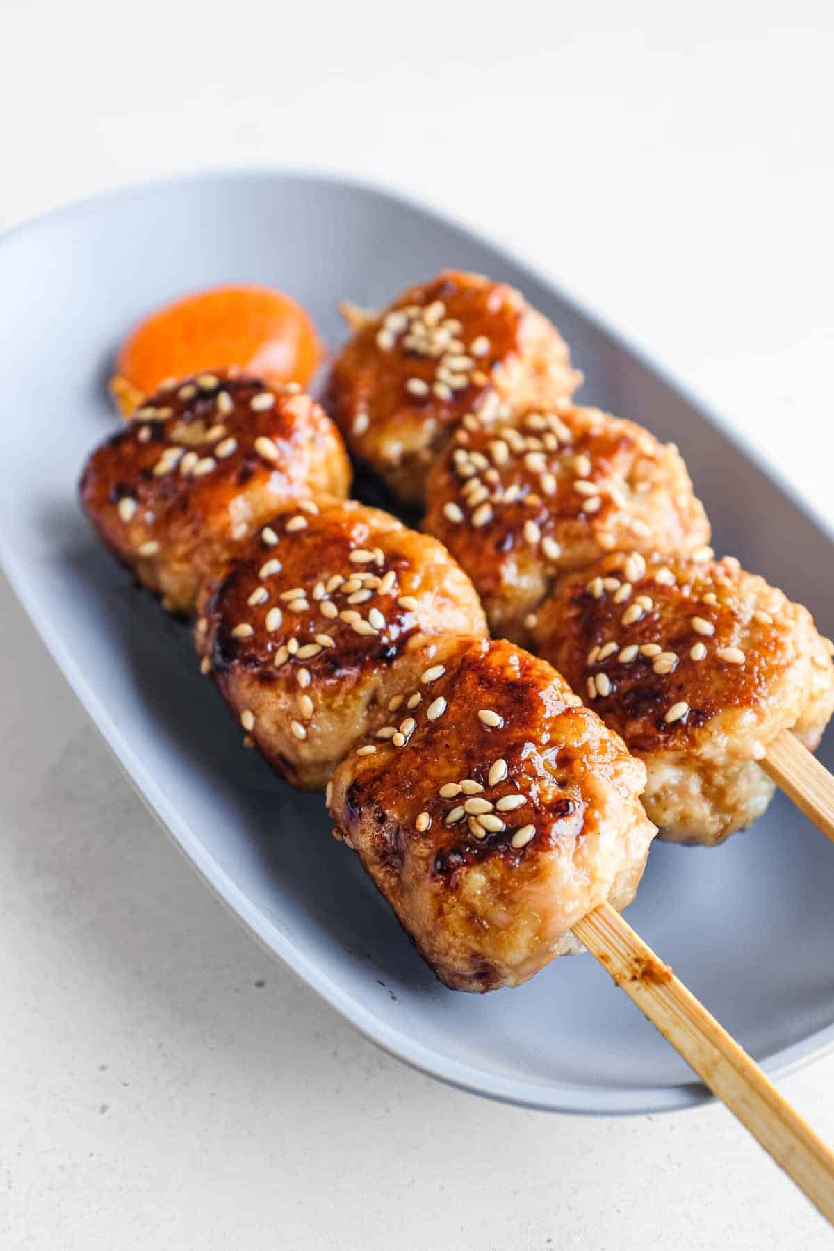 Close-up of juicy Japanese chicken meatballs coated in a glossy sweet and savoury tare sauce