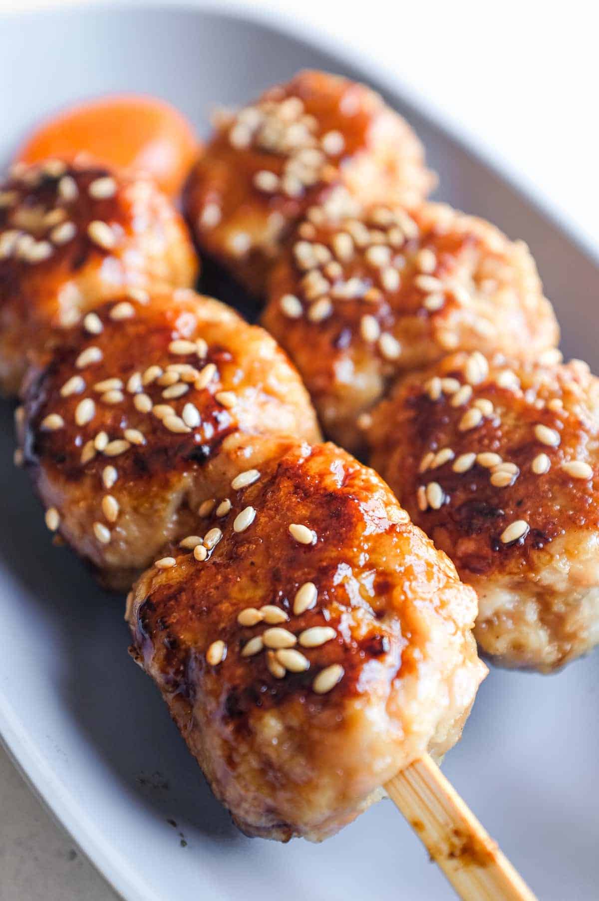 Close-up of juicy Japanese chicken meatballs coated in a glossy sweet and savoury tare sauce