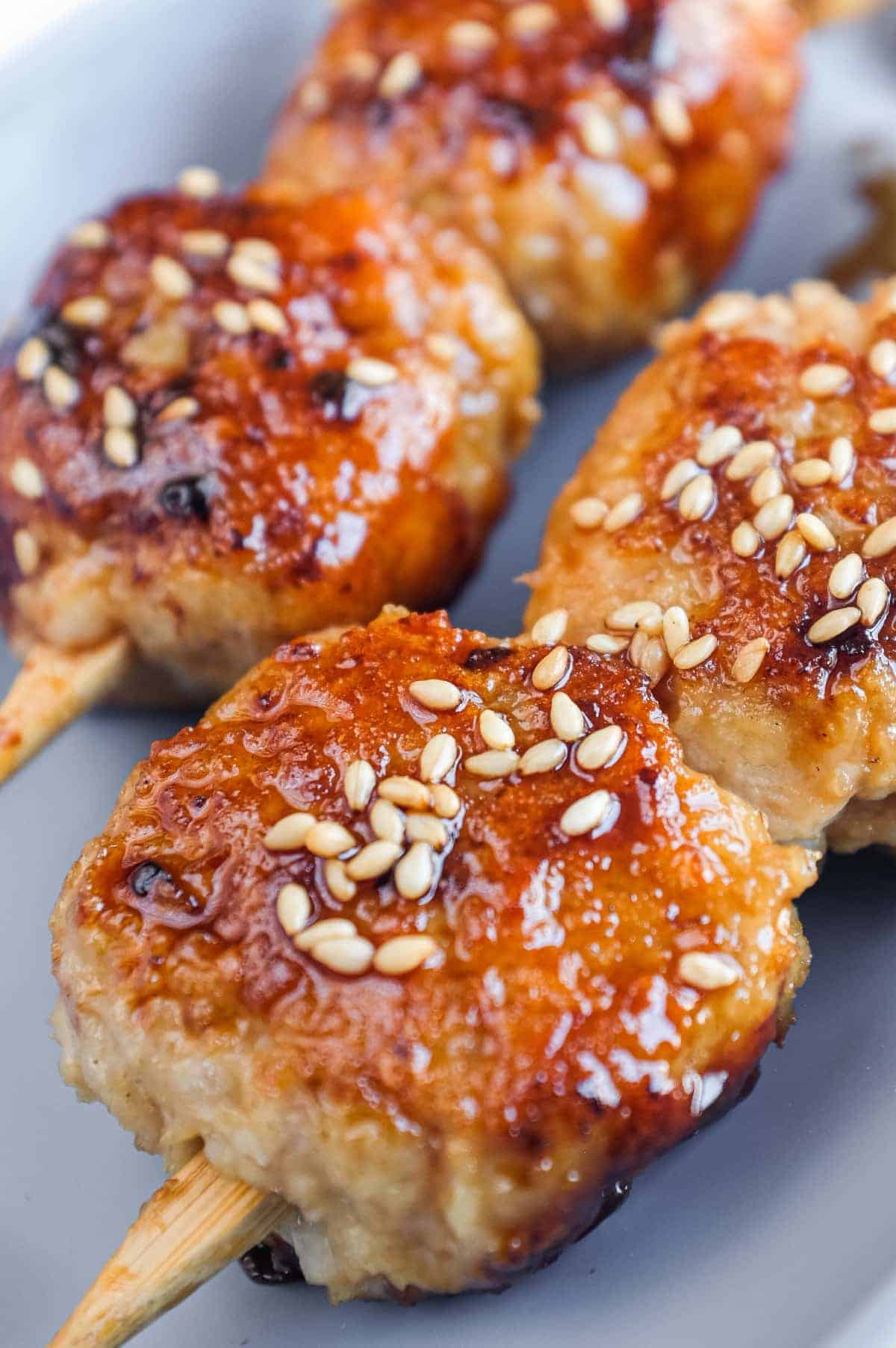 Close-up of juicy Japanese chicken meatballs coated in a glossy sweet and savoury tare sauce