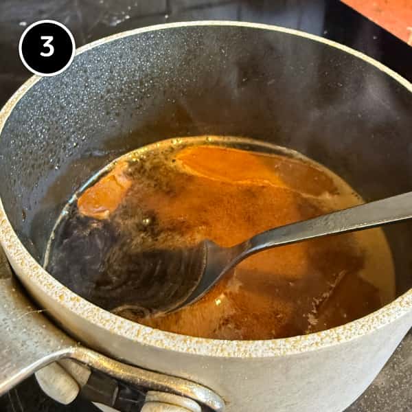Tsukune (Japanese Chicken Meatballs) | cookeatworld.com A small pan of tare sauce simmering