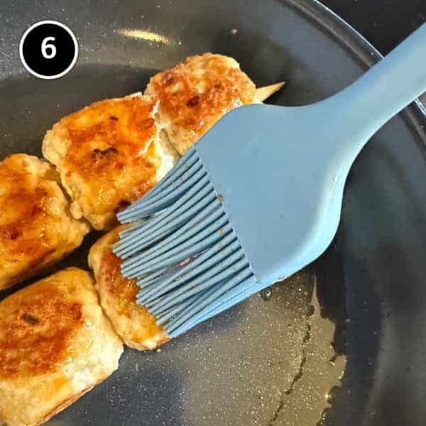 Tsukune (Japanese Chicken Meatballs) | cookeatworld.com Japanese chicken meatballs brushed with tare during the final minute of cooking