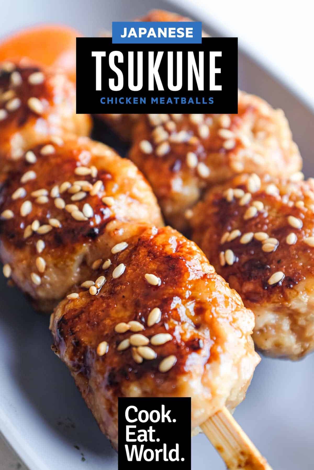 Pan-fried tsukune skewers served with extra tare sauce and toasted sesame seeds