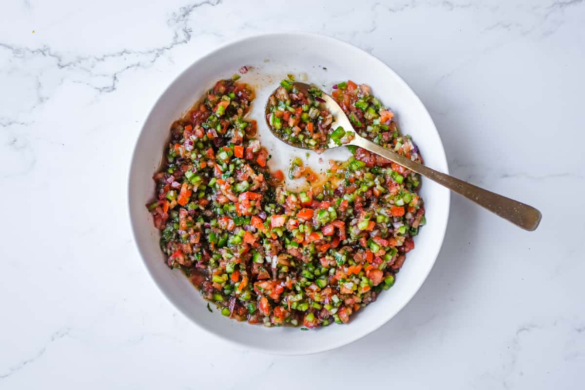 A refreshing bowl of Turkish Spoon Salad alongside grilled kebabs and Mediterranean side dishes.