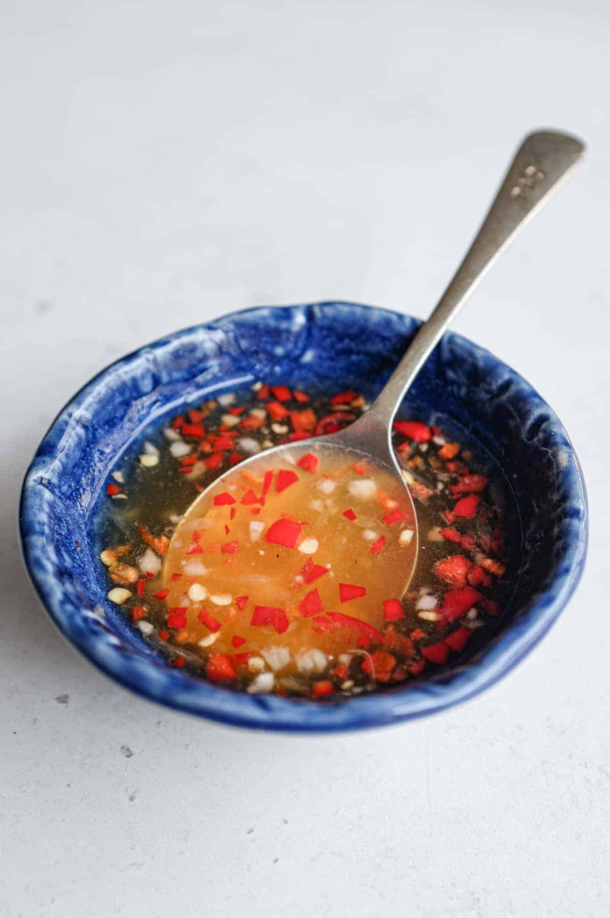 Freshly chopped garlic and red chilli in Vietnamese dipping sauce