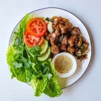 Vietnamese shaking beef served in crisp lettuce cups with fresh herbs