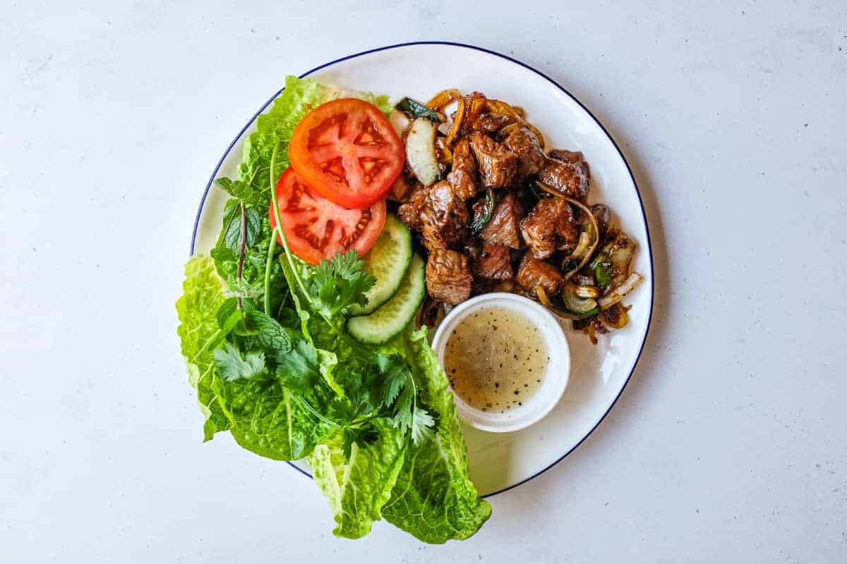 Vietnamese shaking beef served in crisp lettuce cups with fresh herbs