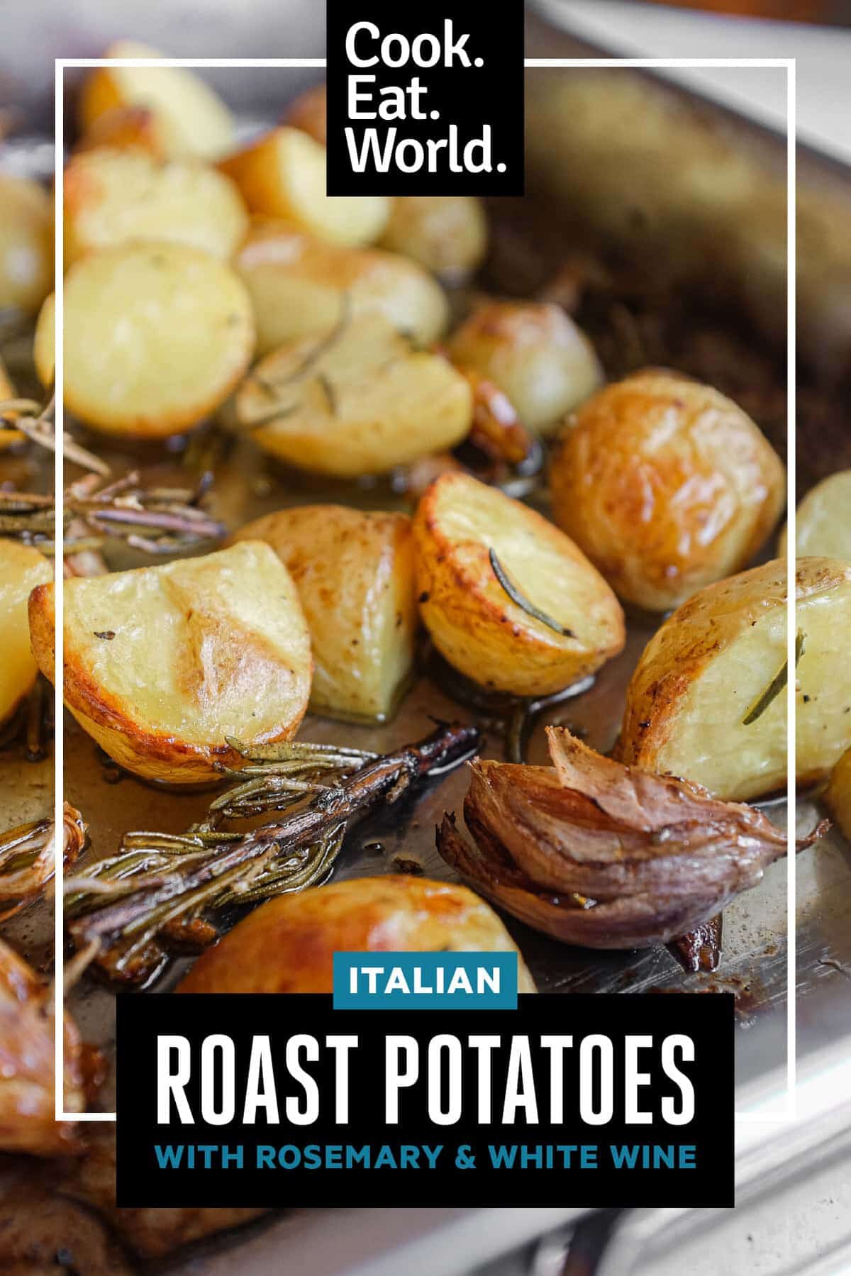 Close-up of Italian roast potatoes with rosemary and garlic in a baking tin.